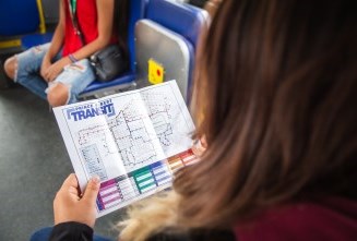 a woman viewing a printed map on a bus