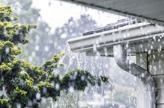 Home with soffit overflowing with water