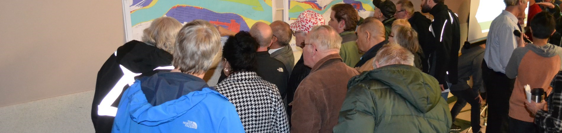 members of the public gather to view display