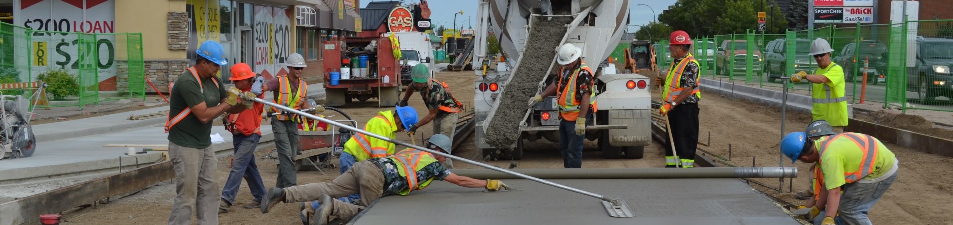 Crews laying cement on 2nd Avenue West