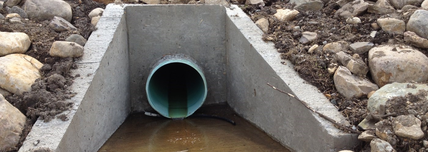 storm water outlet along the riverbank