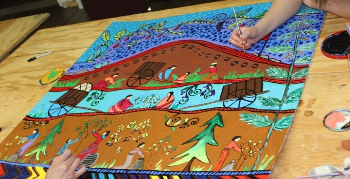 people painting a mural