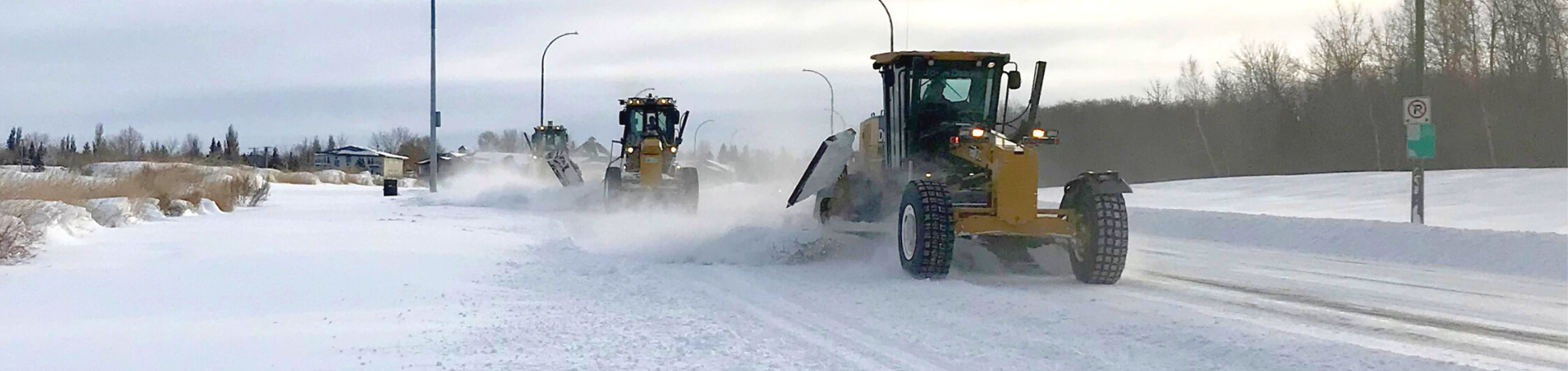 three graders clear snow on 15th Street East