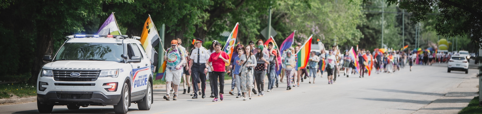 Parade of people walking with police escort