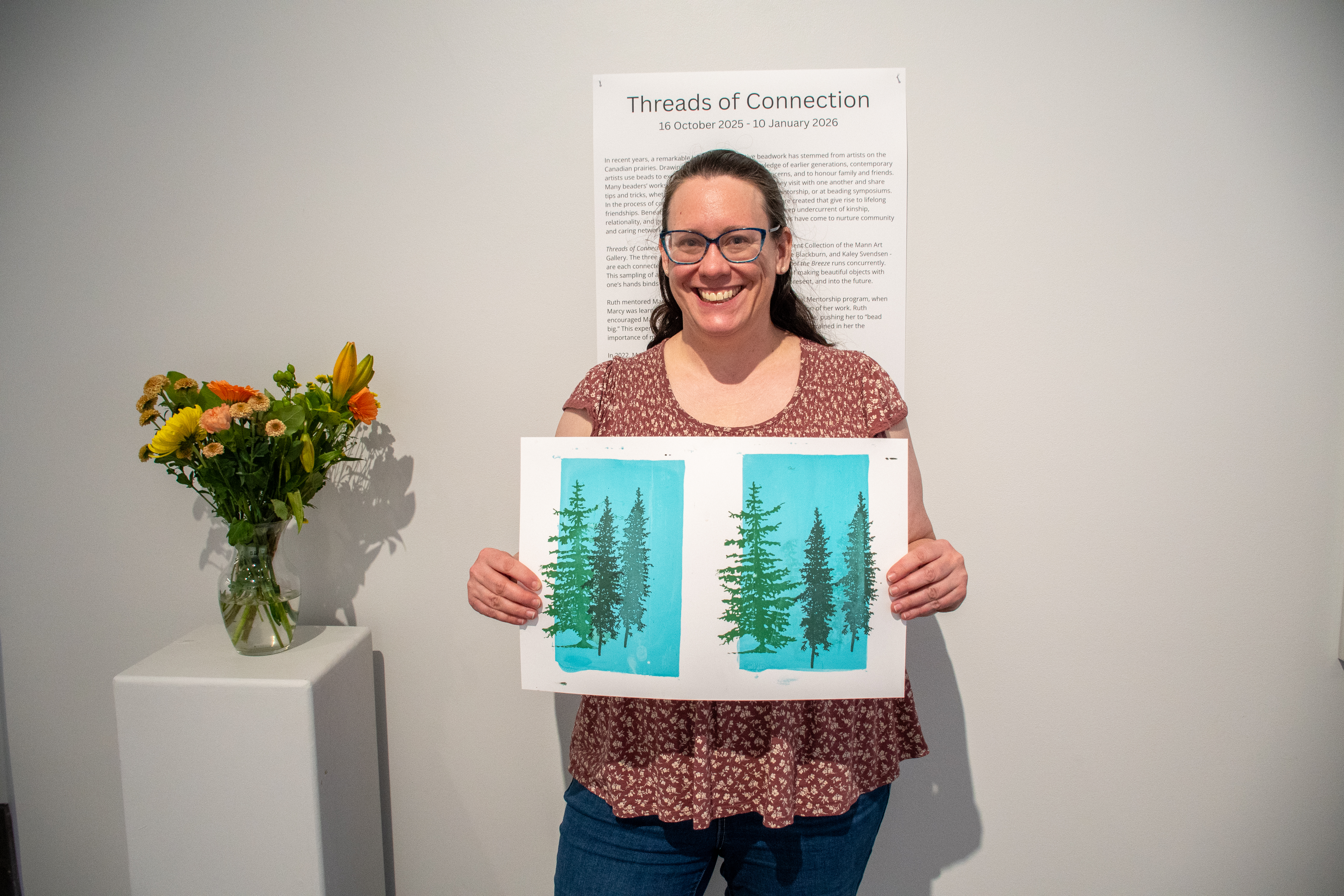 Lana Wilson smiling and holding examples of screenprints