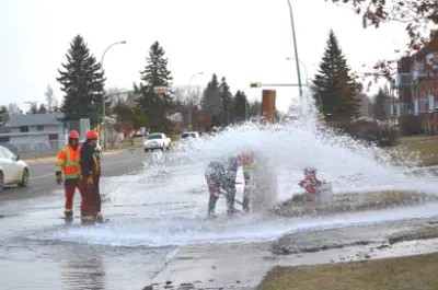 City crews working on a bursting fire hydrant